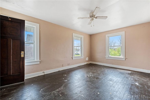 unfurnished room with wood-type flooring, baseboards, and ceiling fan
