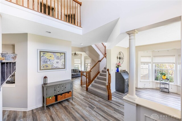 3513 Black Squirrel Way, Springboro, OH 45005 - foyer entrance featuring wood finished floors, stairway, ornate columns, and baseboards