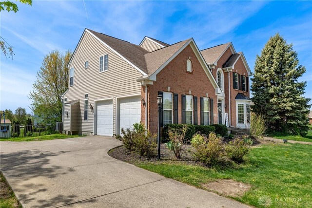 3513 Black Squirrel Way, Springboro, OH 45005 - view of property exterior with concrete driveway, an attached garage, brick siding, and roof with shingles