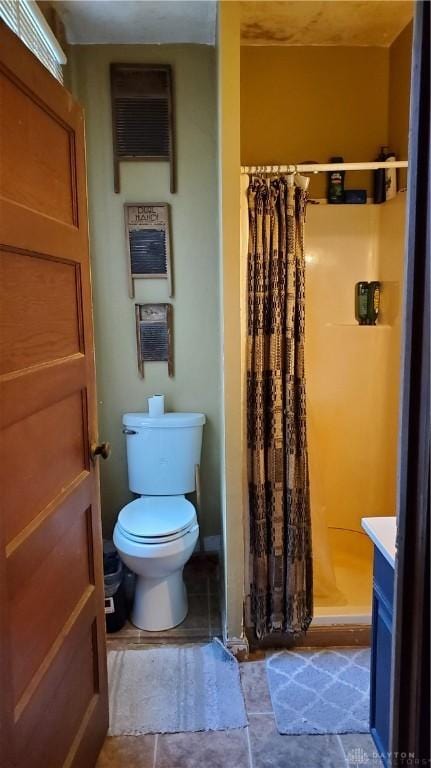 full bathroom with a shower stall, toilet, and vanity