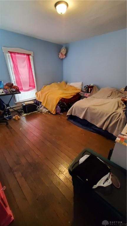 bedroom with wood-type flooring