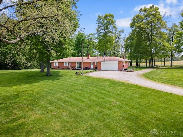 2848 Hollansburg Sampson Rd, New Madison, OH 45346 - ranch-style home with driveway, an attached garage, a front lawn, and a chimney