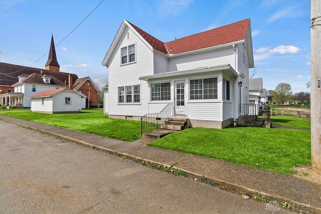 203 W Plum St, Saint Paris, OH 43072 - traditional home featuring a front yard, entry steps, and a shingled roof