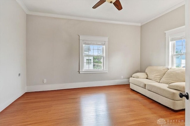 203 W Plum St, Saint Paris, OH 43072 - living area featuring healthy amount of natural light, a ceiling fan, light wood-style floors, ornamental molding, and baseboards