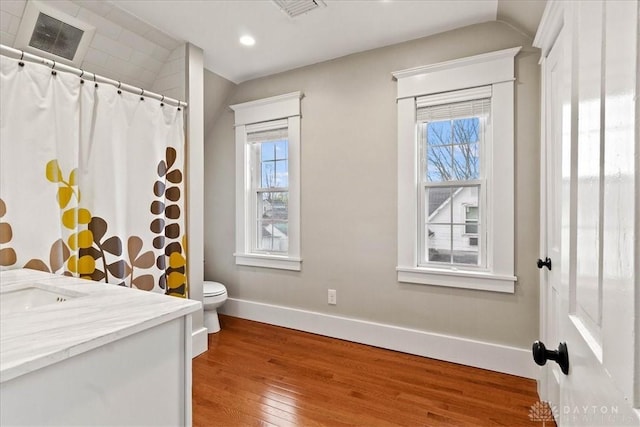 203 W Plum St, Saint Paris, OH 43072 - bathroom featuring hardwood / wood-style floors, lofted ceiling, plenty of natural light, toilet, and baseboards