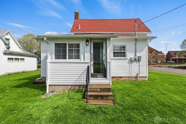 203 W Plum St, Saint Paris, OH 43072 - rear view of property with entry steps, a yard, and a chimney