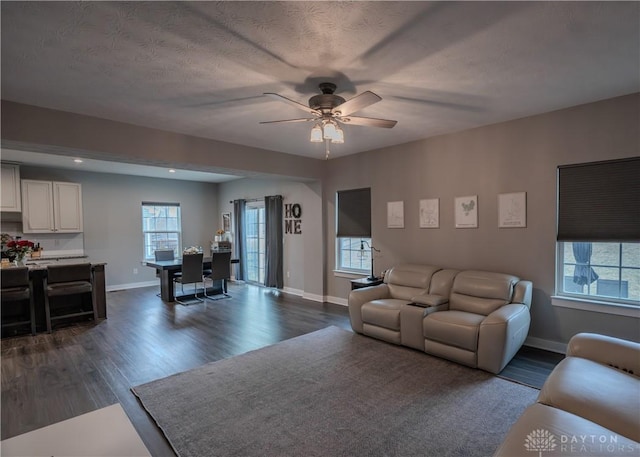 1180 Autumn Ridge Dr, Lebanon, OH 45036 - living room featuring baseboards, a ceiling fan, and dark wood-type flooring