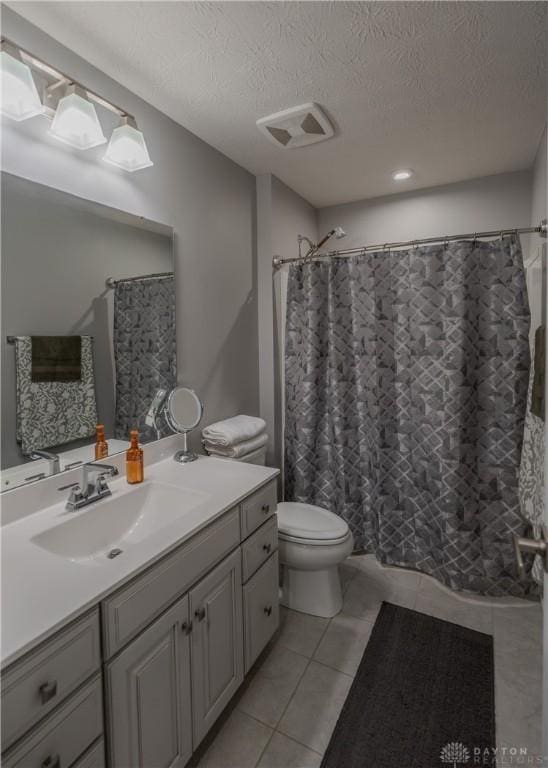 1180 Autumn Ridge Dr, Lebanon, OH 45036 - bathroom featuring a textured ceiling, toilet, visible vents, tile patterned flooring, and vanity