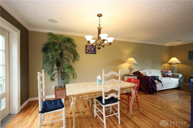 115 Southlake Dr, Dayton, OH 45459 - dining room featuring a chandelier, light wood-type flooring, crown molding, baseboards, and healthy amount of natural light