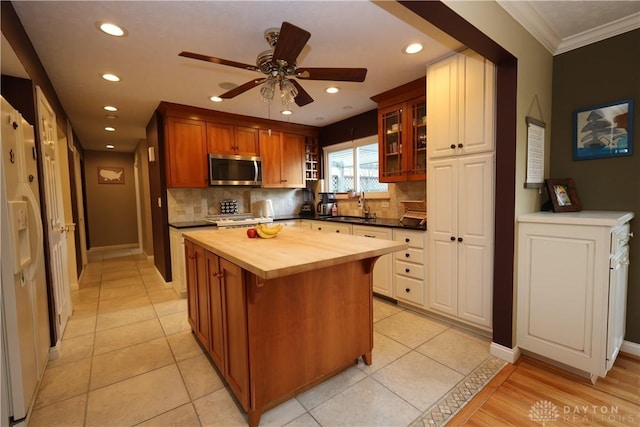 115 Southlake Dr, Dayton, OH 45459 - kitchen featuring stainless steel microwave, butcher block counters, a sink, decorative backsplash, and ceiling fan