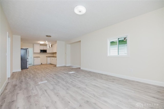 unfurnished living room featuring baseboards and light wood-style floors