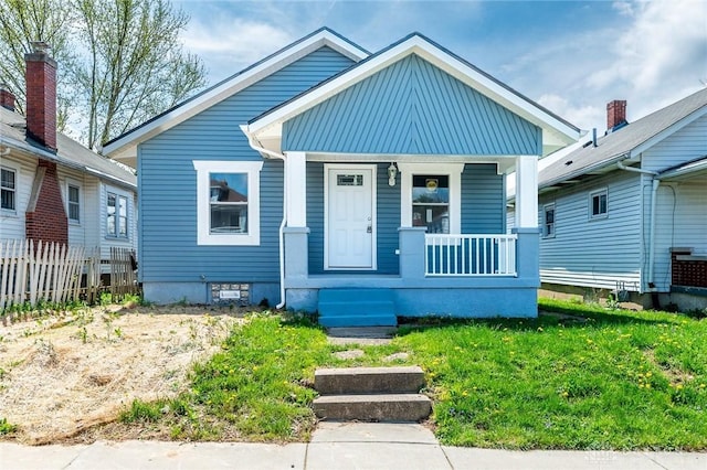 view of front of house featuring a porch and fence