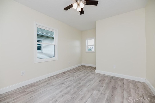 empty room featuring light wood-type flooring, baseboards, and ceiling fan