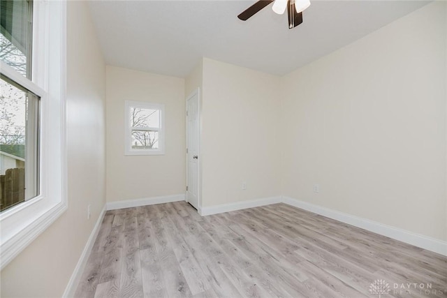unfurnished room featuring light wood finished floors, baseboards, and ceiling fan