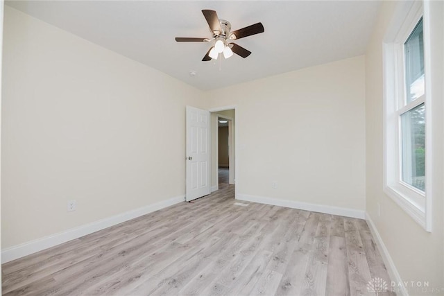 unfurnished room featuring baseboards, a ceiling fan, and light wood finished floors