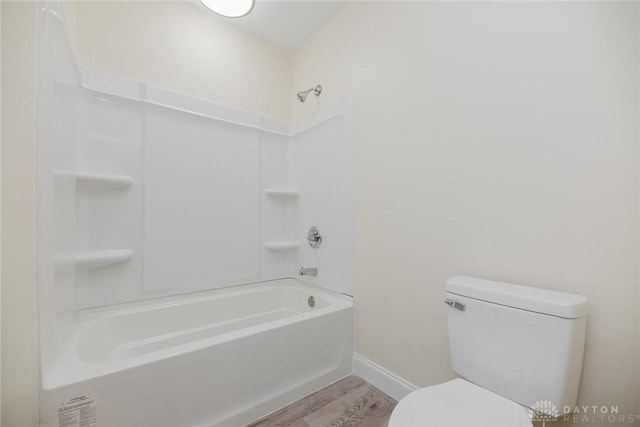 bathroom with toilet, wood finished floors, and baseboards
