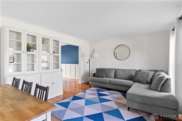 living room with baseboards and light wood finished floors
