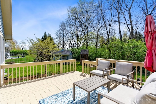 wooden deck featuring an outdoor structure and outdoor lounge area