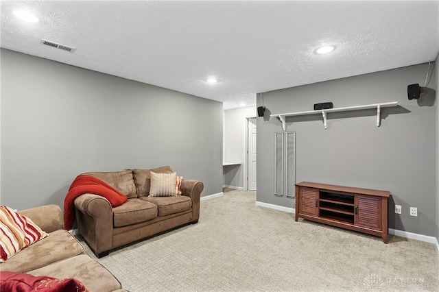 carpeted living room with visible vents, baseboards, recessed lighting, and a textured ceiling