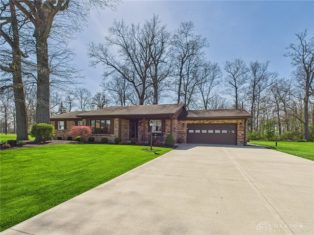 view of front of home featuring concrete driveway, brick siding, a front yard, and a garage
