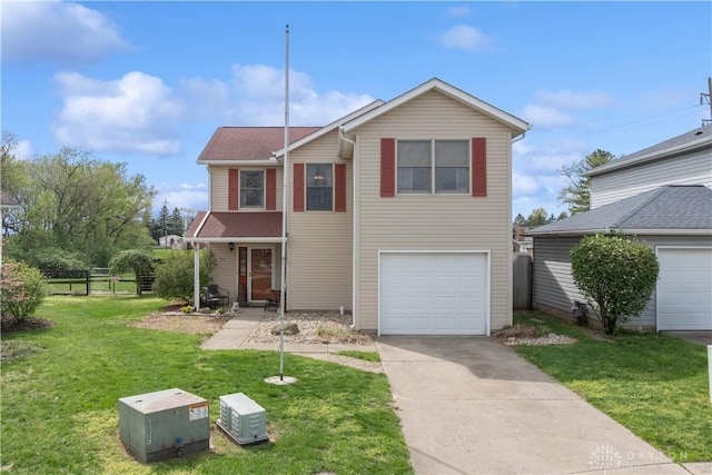traditional home with fence, a front lawn, driveway, and a garage