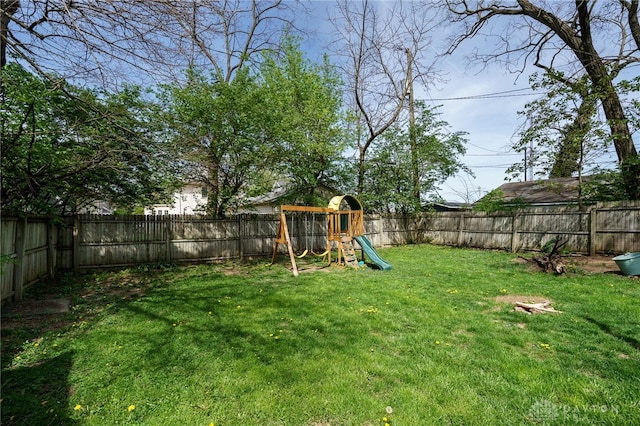 view of yard with a fenced backyard and a playground