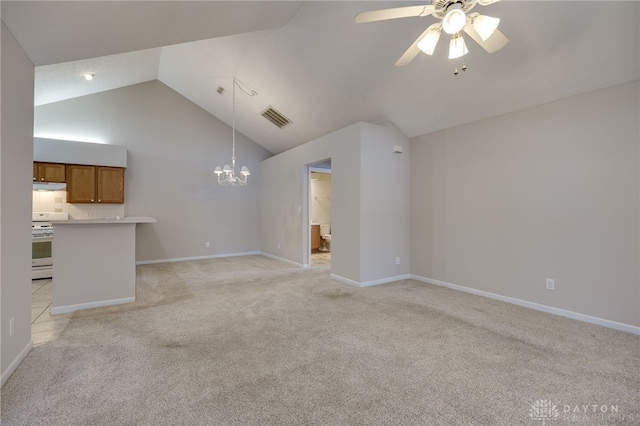 unfurnished living room with vaulted ceiling, visible vents, light carpet, baseboards, and ceiling fan with notable chandelier