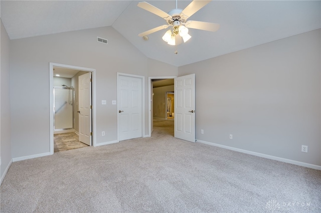 unfurnished bedroom featuring baseboards, vaulted ceiling, visible vents, and light colored carpet