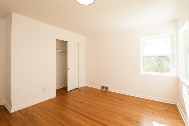 4035 Myron Ave, Dayton, OH 45416 - unfurnished bedroom with light wood-style flooring, baseboards, and a closet