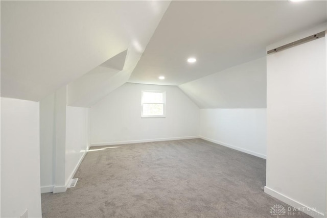 bonus room with vaulted ceiling, baseboards, carpet flooring, visible vents, and recessed lighting