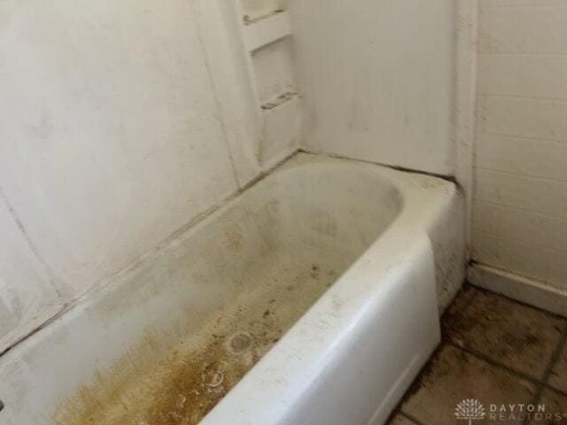 full bath featuring a tub to relax in