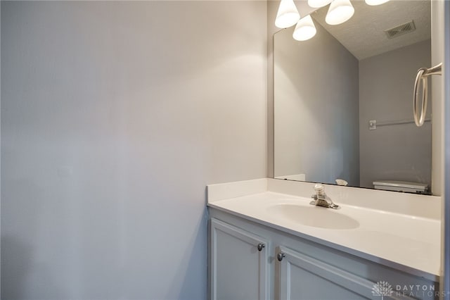 2454 Cabbage Key Dr, Miamisburg, OH 45342 - bathroom featuring visible vents, a textured ceiling, and vanity