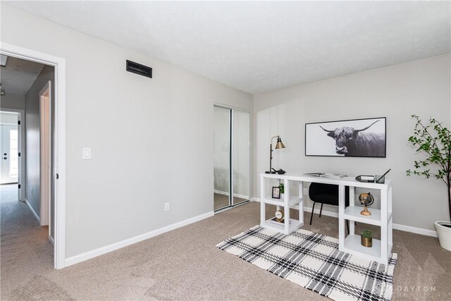 carpeted home office featuring baseboards and visible vents
