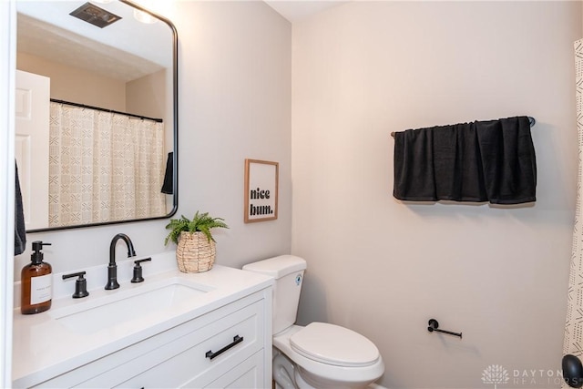 bathroom with toilet and vanity