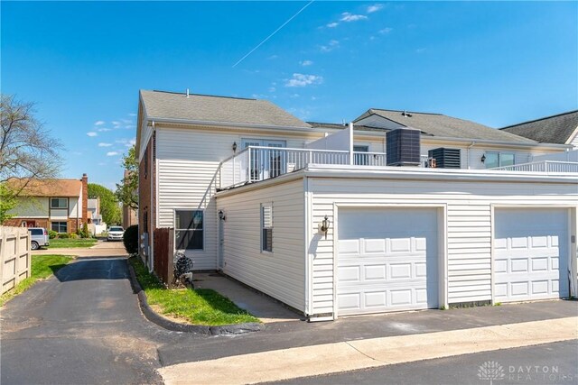 view of front of home featuring a garage and a balcony