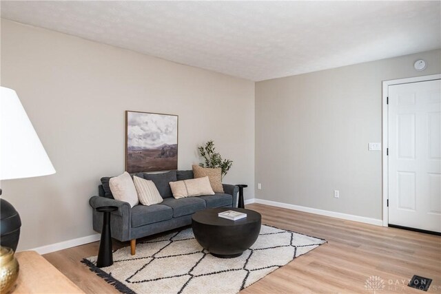 living area featuring wood finished floors and baseboards