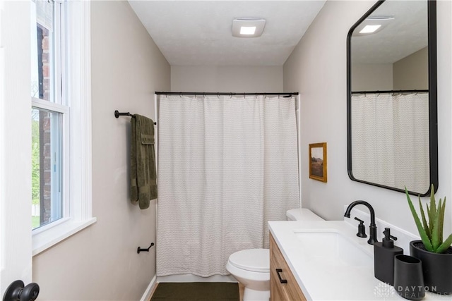 full bath with vanity, curtained shower, and toilet