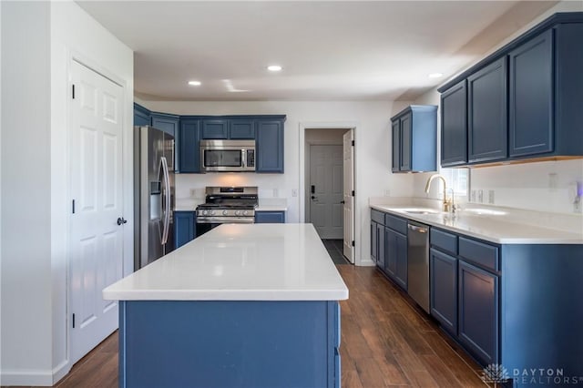 4100 Joshane St, Springfield, OH 45502 - kitchen featuring blue cabinets, a sink, dark wood-style flooring, recessed lighting, and appliances with stainless steel finishes