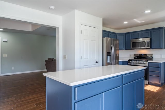 4100 Joshane St, Springfield, OH 45502 - kitchen with light countertops, dark wood-style floors, blue cabinetry, and appliances with stainless steel finishes