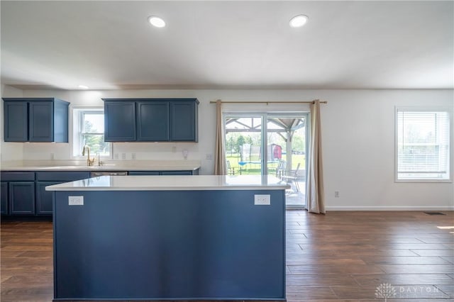 4100 Joshane St, Springfield, OH 45502 - kitchen with light countertops, a center island, a sink, and a wealth of natural light
