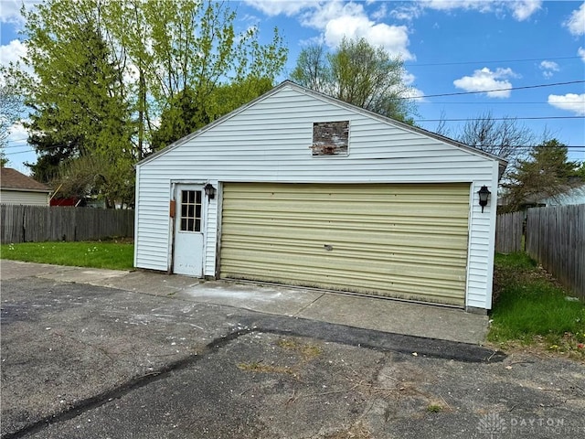 detached garage featuring fence