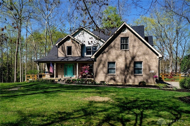 9171 Big Oak Dr, Washington Twp, OH 45458 - view of front of house with covered porch, a front yard, and brick siding