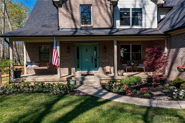 9171 Big Oak Dr, Washington Twp, OH 45458 - property entrance with covered porch, brick siding, and a yard