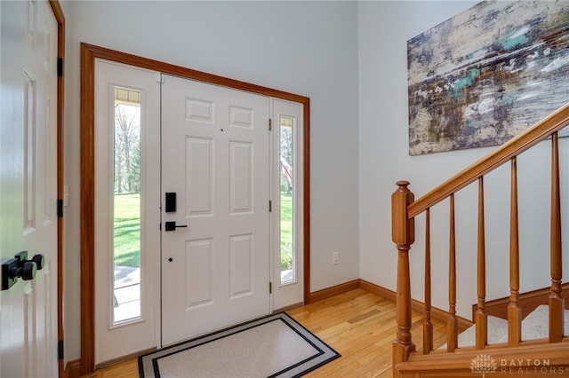 9171 Big Oak Dr, Washington Twp, OH 45458 - foyer featuring stairs, light wood finished floors, and plenty of natural light