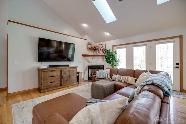 9171 Big Oak Dr, Washington Twp, OH 45458 - living room with a skylight, light wood-style flooring, a high end fireplace, baseboards, and high vaulted ceiling