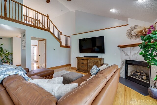 9171 Big Oak Dr, Washington Twp, OH 45458 - living area featuring wood finished floors, high vaulted ceiling, a fireplace, and baseboards