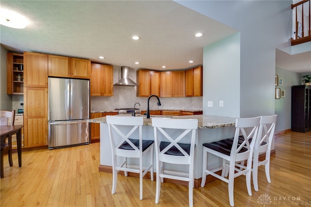 9171 Big Oak Dr, Washington Twp, OH 45458 - kitchen featuring freestanding refrigerator, wall chimney exhaust hood, a sink, backsplash, and recessed lighting