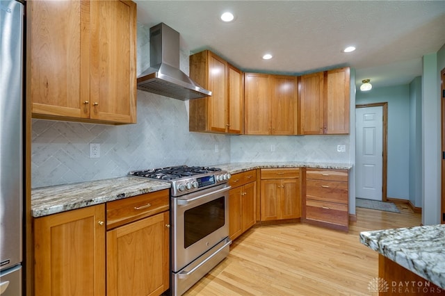 9171 Big Oak Dr, Washington Twp, OH 45458 - kitchen featuring appliances with stainless steel finishes, wall chimney exhaust hood, light stone countertops, backsplash, and light wood-style floors