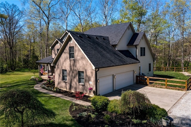 9171 Big Oak Dr, Washington Twp, OH 45458 - view of side of home featuring an attached garage, a shingled roof, concrete driveway, and brick siding
