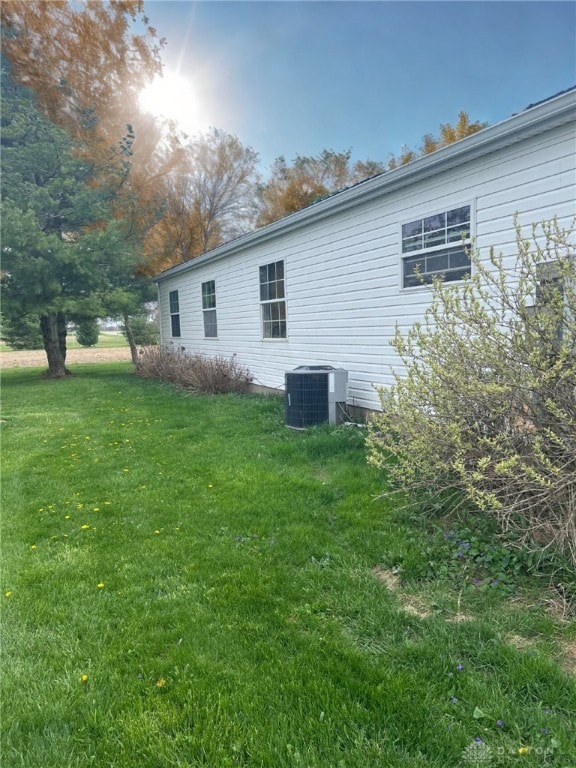 14384 NW US Highway 35, Jeffersonville, OH 43128 - view of property exterior featuring central air condition unit and a yard